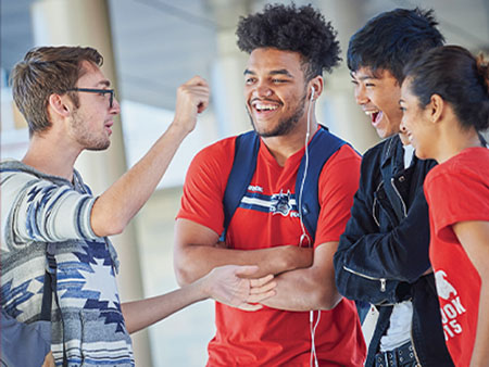 A group of students talking on campus.